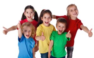 Five children posing with their thumbs up and smiling