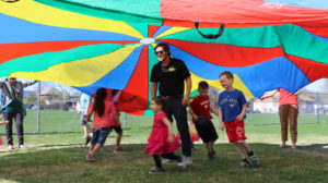 Kids playing under parachute