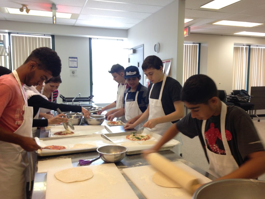 Youth rolling dough