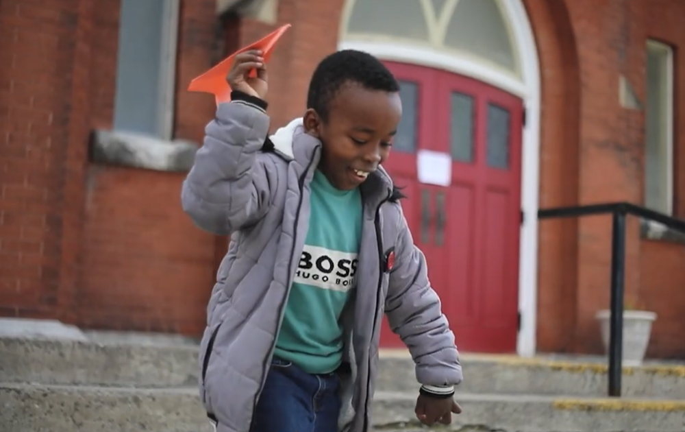 Boy with paper airplane
