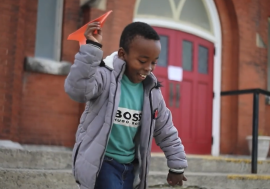 Boy with paper airplane